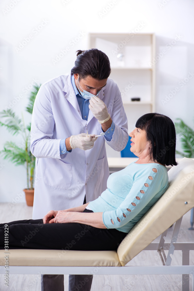 Old woman visiting young doctor dentist Old woman visiting young doctor dentist
