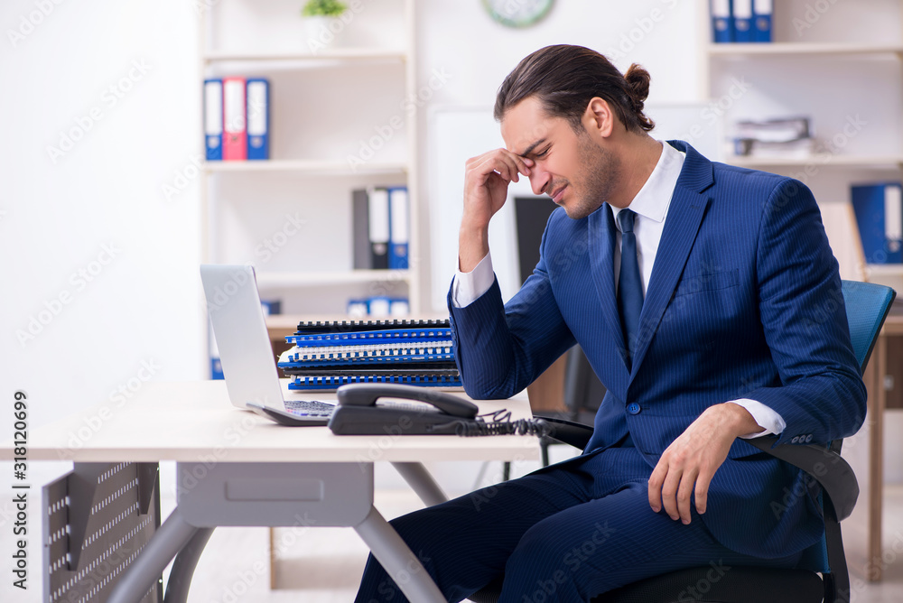 Young male businessman working in the office