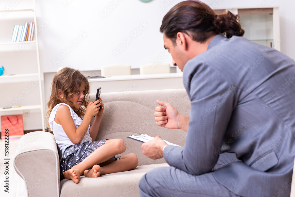 Child psychologist attending small girl Child psychologist attending small girl