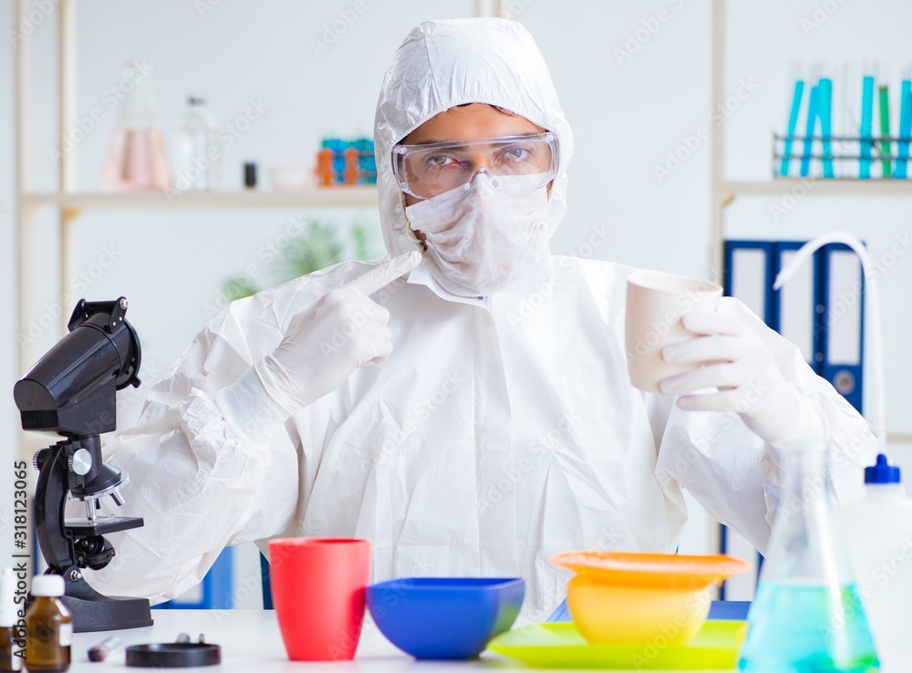 Chemist checking and testing plastic dishes