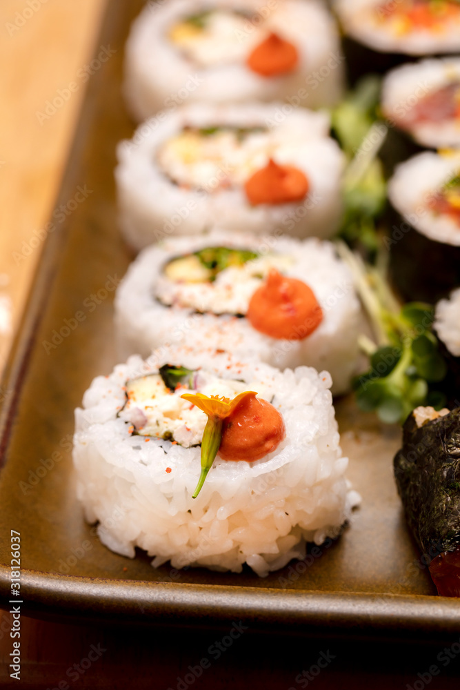 Inside and outside Sushi Rolls decorated with flowers and trimmings Inside and outside Sushi Rolls decorated with flowers and trimmings