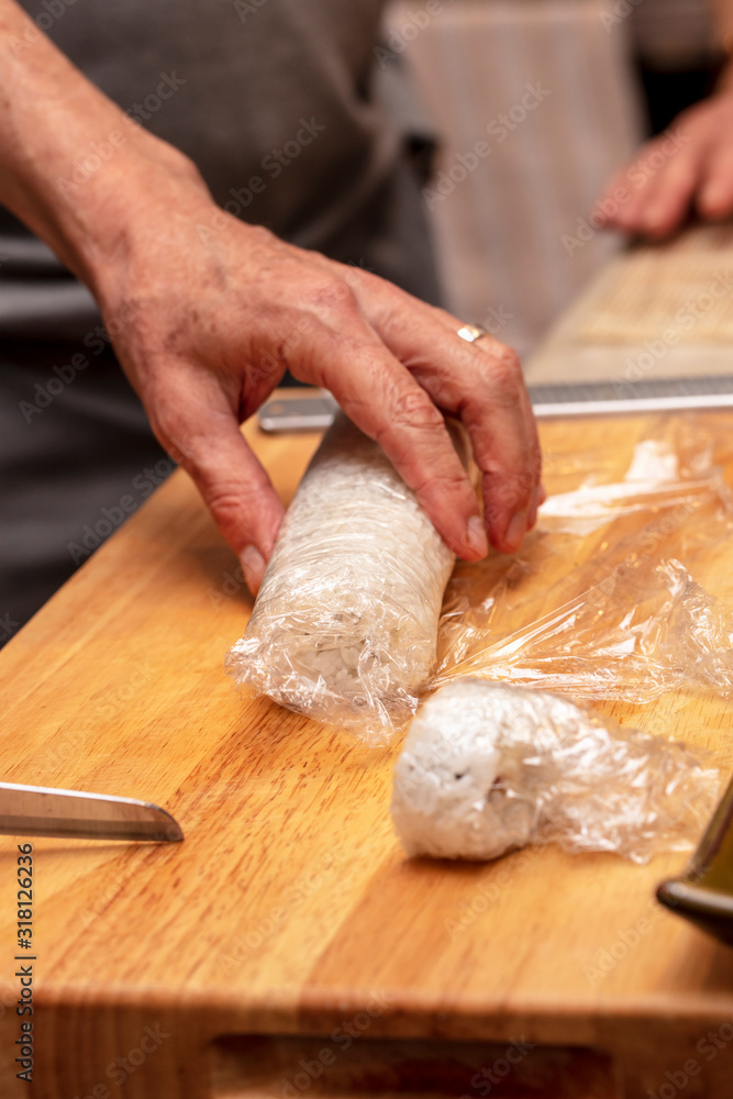 Chef rooling the sushi rice in a demonstration class