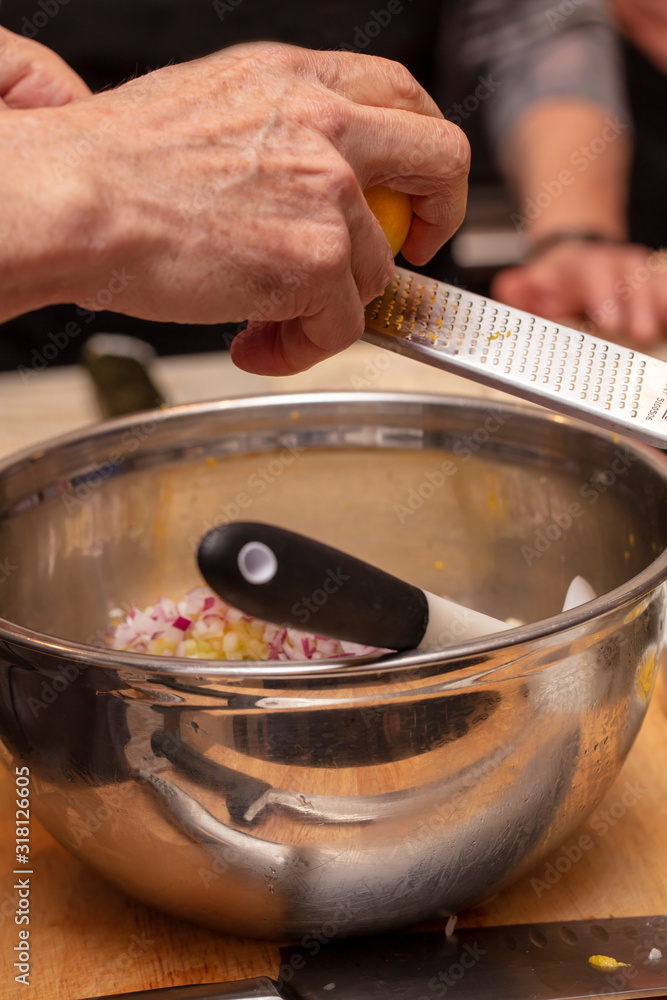 Sushi roll being sliced in a demonstaration class Sushi roll being sliced in a demonstaration class