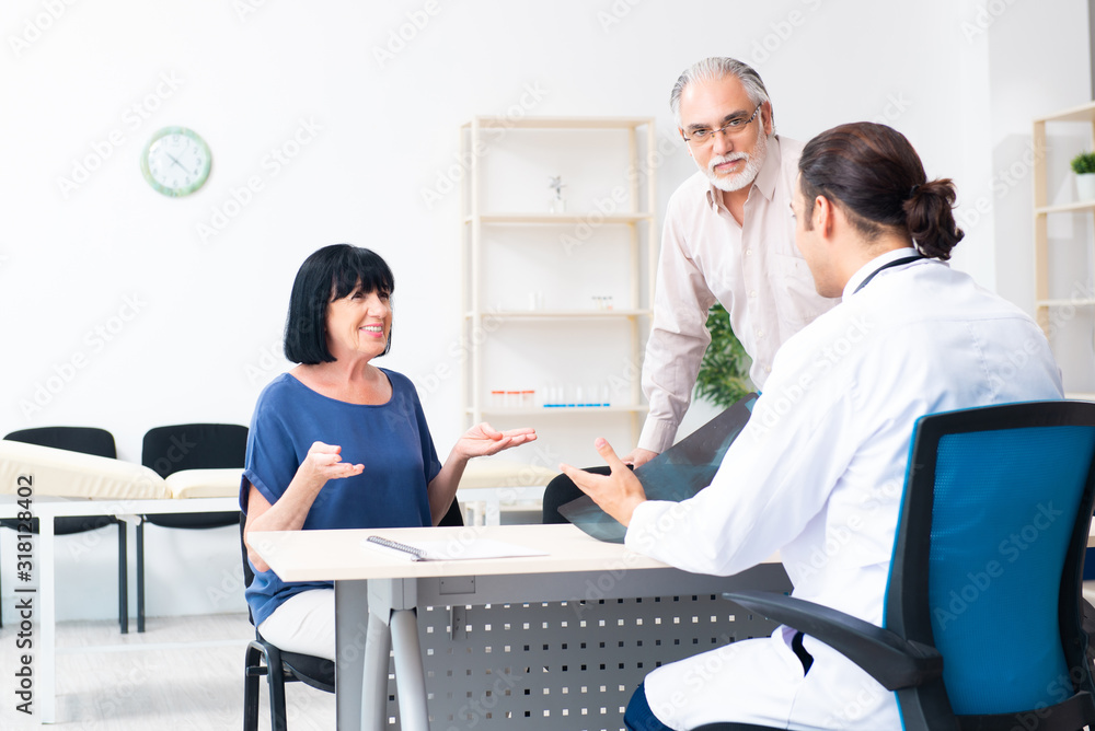 Fototapeta premium Old couple visiting young male doctor
