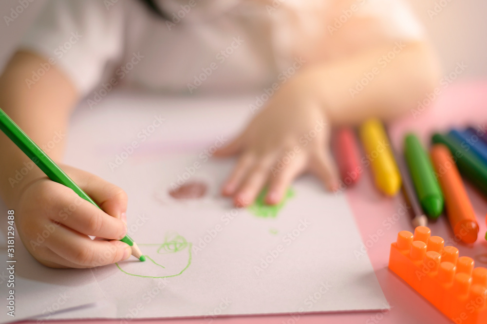 Little curly asian girl enjoy drawing at home. Education Concept. Little curly asian girl enjoy drawing at home. Education Concept.
