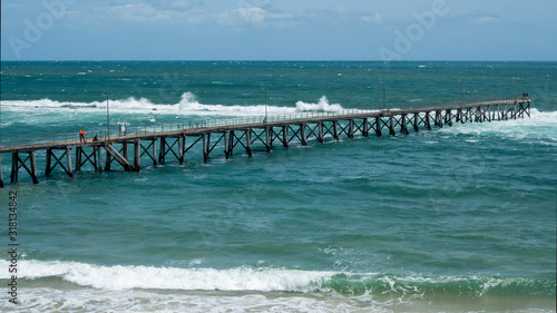 The Port Noarlunga Jetty with rough ocean hitting the reef in South Australia on 23rd January 2020