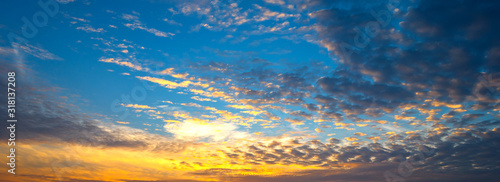 Panorama Sunset with clouds, in orange and colorful shades,World Environment Day concept: Fiery orange sunset sky with dark clouds. © noon@photo