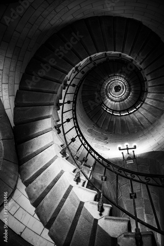 Incredible spiral staircase to the top of Eckmuhl lighthouse, on the Penmarsh Peninsula. Black and white image. Brittany. France
