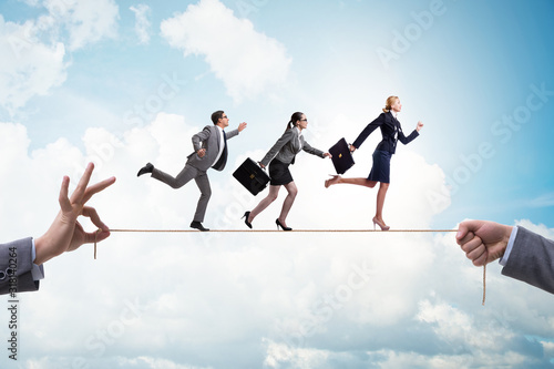 Business people walking on tight rope