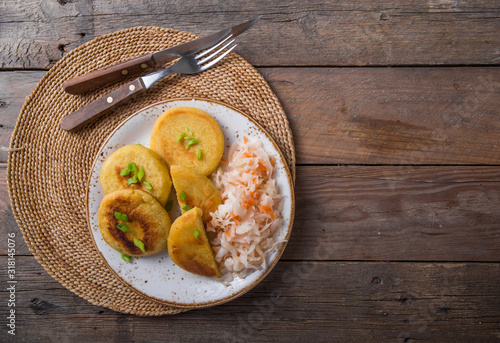 Fotografija Salvadoran pupusa served with curtido  on board. view from above