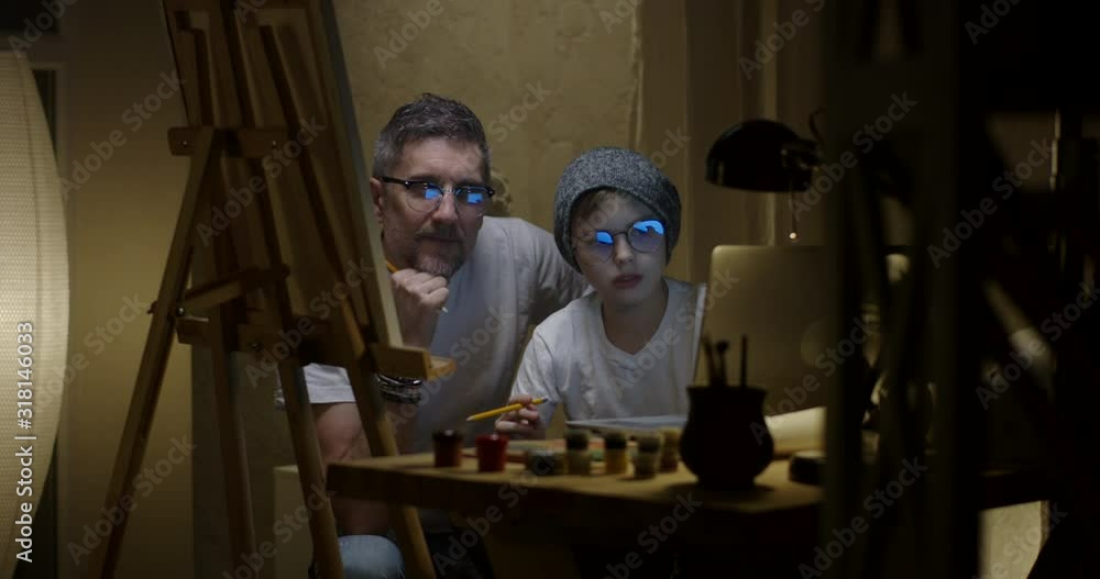 Artist and son painting together Artist and son painting together