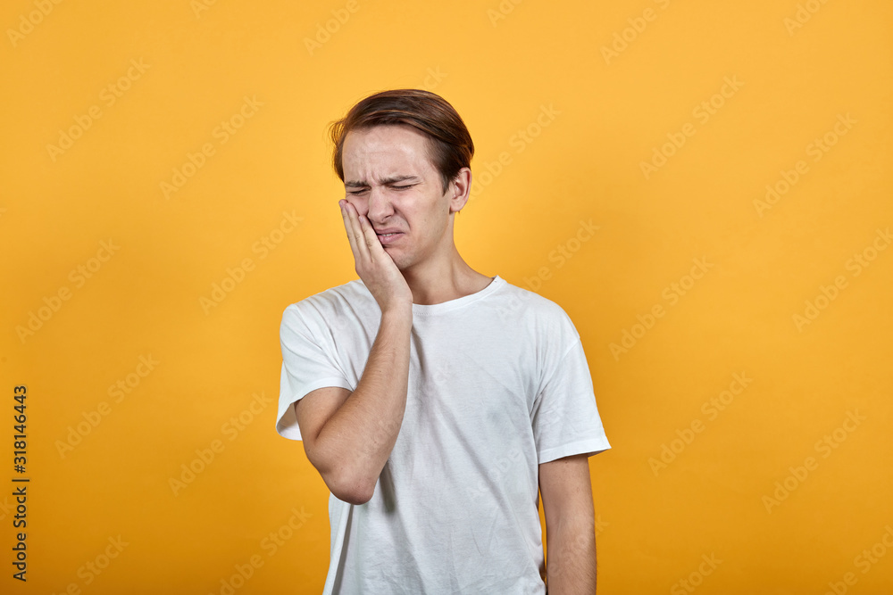 Man holds his hand near the face with a toothache Man holds his hand near the face with a toothache