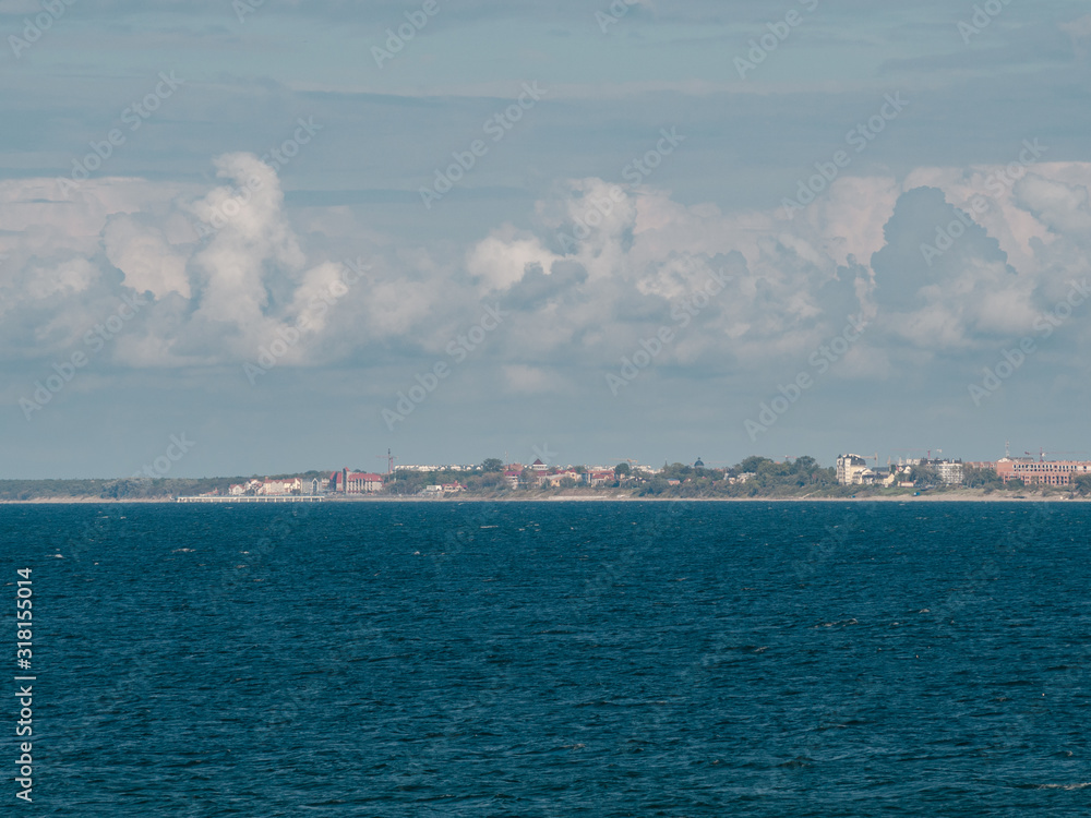 Seascape, calm sea, Zelenogradsk city in the background. Cloudscape, Baltic sea