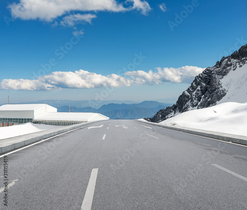 Snowy road under freezing blue sky