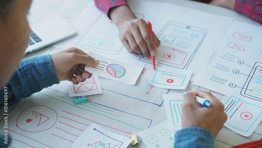 Designers man drawing (UX) (UI) Graphic designer creative sketch planning application process development prototype for application on smartphone Designers man drawing (UX) (UI) Graphic designer creative sketch planning application process development prototype for application on smartphone