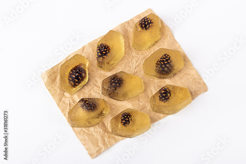 Healthy vegan snack - natural jelly marmalade with pine cone inside on white background.The concept of proper nutrition and healthy eating. Organic and vegetarian sweet dessert no bake. Close up photo