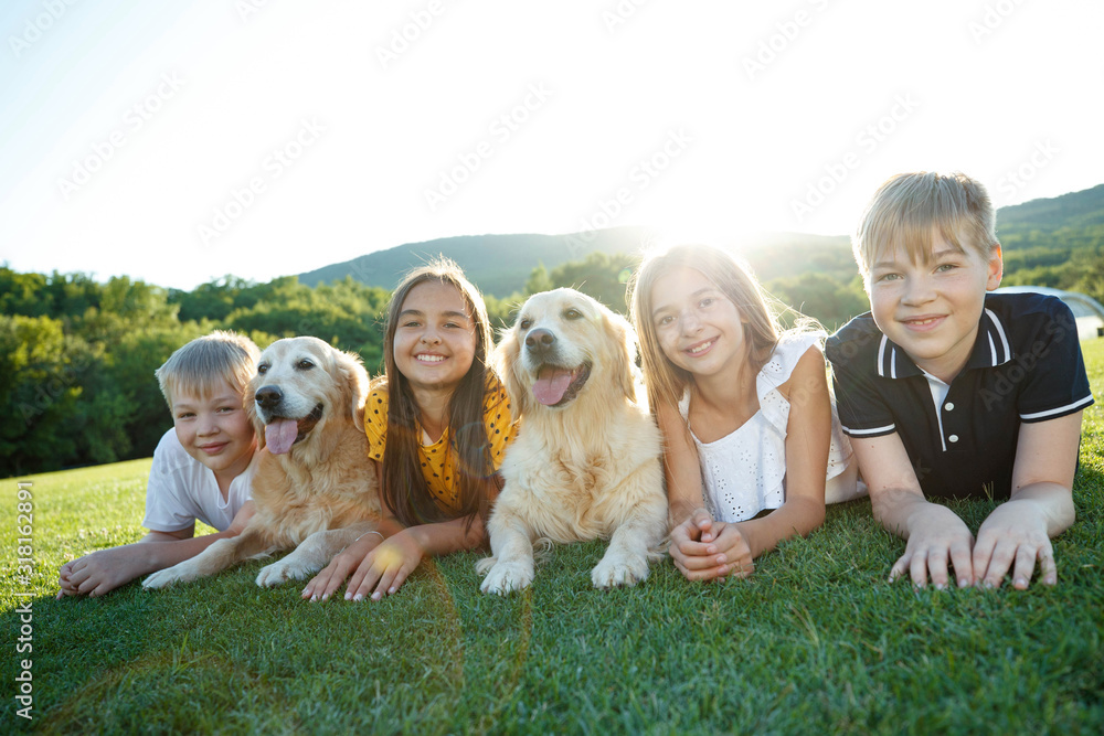 Children with a dog. A group of children are playing outdoors with a dog. Children with a dog. A group of children are playing outdoors with a dog.