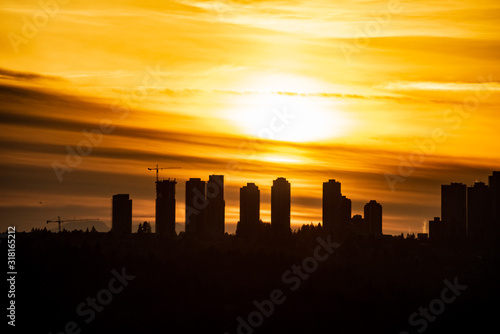 Metrotown silhouette on sunset cloudy sky background.