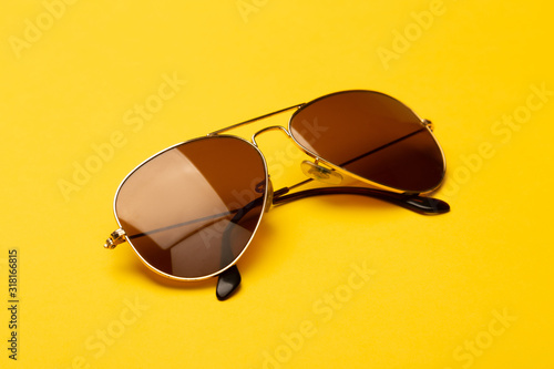 Sunglasses isolated on yellow background.