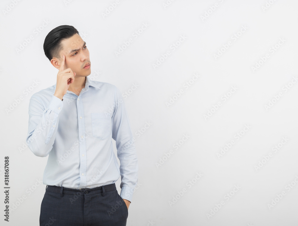 Young handsome asian business man thinking an idea while looking up isolated on white background. Young handsome asian business man thinking an idea while looking up isolated on white background.