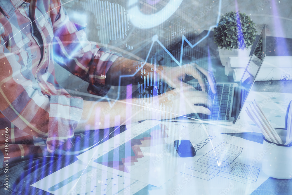 Double exposure of stock graph with businessman typing on computer in office on background. Concept of hard work. Double exposure of stock graph with businessman typing on computer in office on background. Concept of hard work.