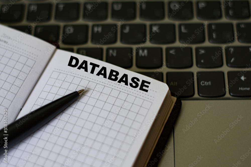 notebook with the word database on the background of a laptop notebook with the word database on the background of a laptop