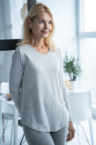 Joyful lady in pajama in dining room stock photo