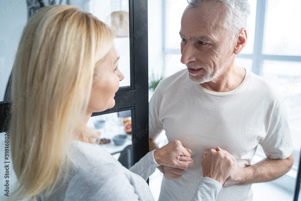 Couple standing hand in hand and smiling stock photo Couple standing hand in hand and smiling stock photo