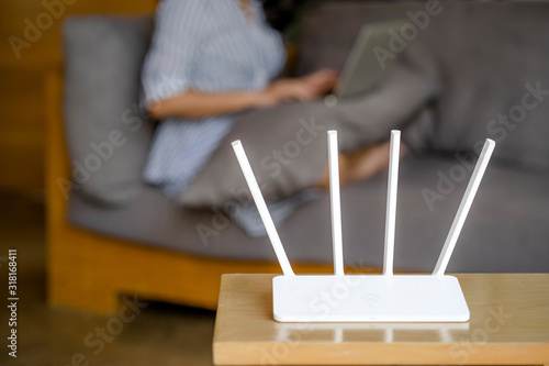 Bild auf Leinwand Wireless router and man using a laptop in office