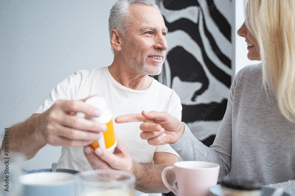 Smiling man and woman with medicines in hands stock photo Smiling man and woman with medicines in hands stock photo