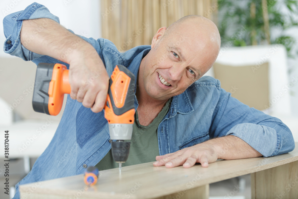 senior man is fixing a furniture senior man is fixing a furniture