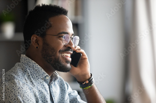 Smiling african business man making business call talking on phone photo