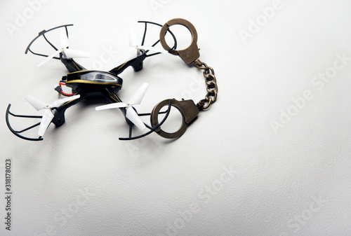 quadcopter handcuffs white leather background
