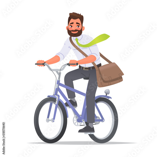 Happy business man rides a bicycle. A cyclist in a business suit rides to work in the office