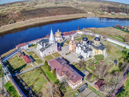 Staritskiy Holy Dormition Monastery is Orthodox monastery in Staritsa town of Tver Oblast, Russia, located on Volga River. Sunny summer day. Aerial view. photo