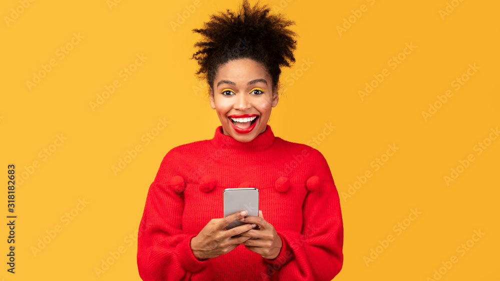 Fotografie Afro girl using mobile phone at studio