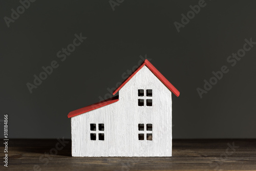 Miniature house on black background. Home construction concept. Front view. © somemeans