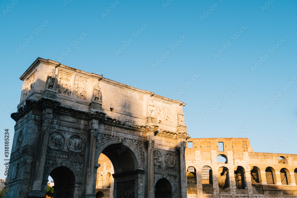 Rome, italy - Dec 23, 2019:  Arch of Constantine and Coliseum  Rome, Italy