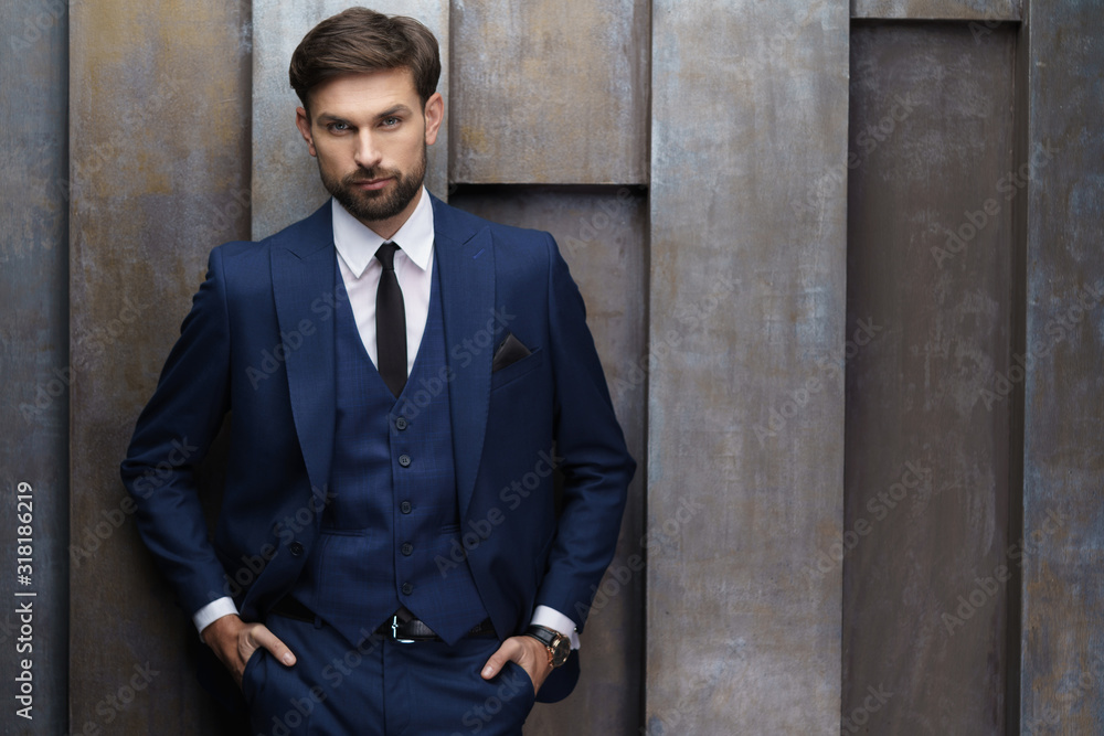 indoor photo of young handsome stylish businessman wearing suit indoor photo of young handsome stylish businessman wearing suit