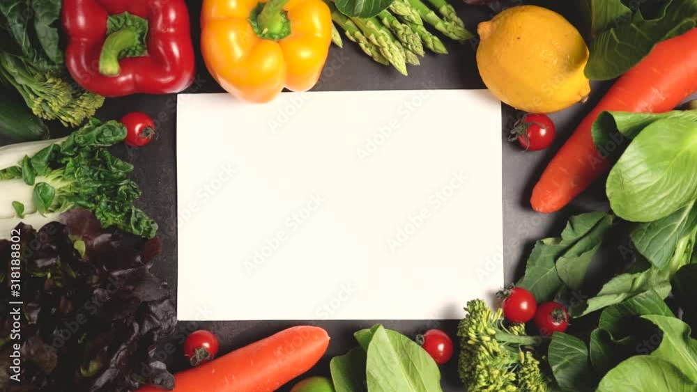 Zoom in fresh organic vegetables setting on table and blank white paper for text, Healthy food concept top view. Slow motion. Zoom in fresh organic vegetables setting on table and blank white paper for text, Healthy food concept top view. Slow motion.