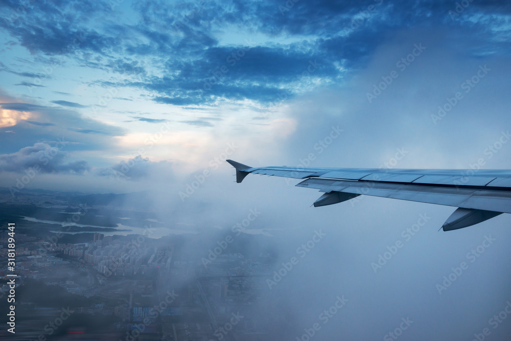 Clouds and sky as seen through window of an aircraft Clouds and sky as seen through window of an aircraft