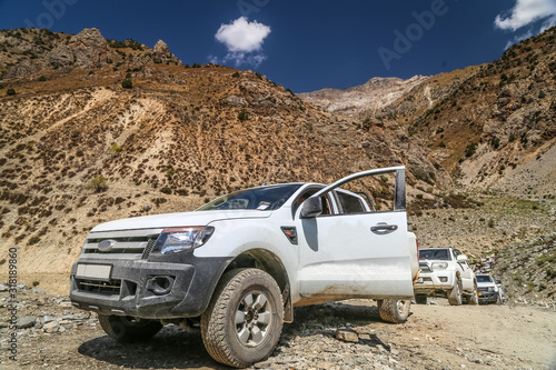 Off-road vehicles on the background of the mountains in Tajikistan