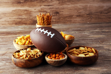Chips, salty snacks, football on a table. Great for Bowl Game snack projects.