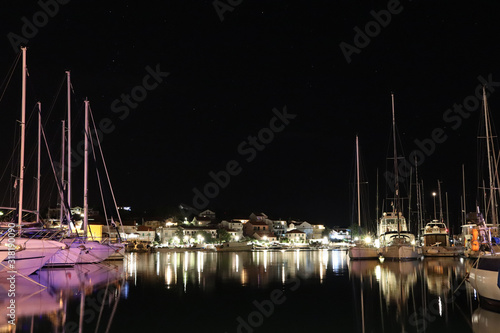 Wallpaper Mural Night parking of yachts in the Croatian ACI marina of the town of Jazira. Burning lights of the evening Mediterranean port with sailing yachts and fishing boats. Twilight on the Adriatic Riviera. Calm Torontodigital.ca