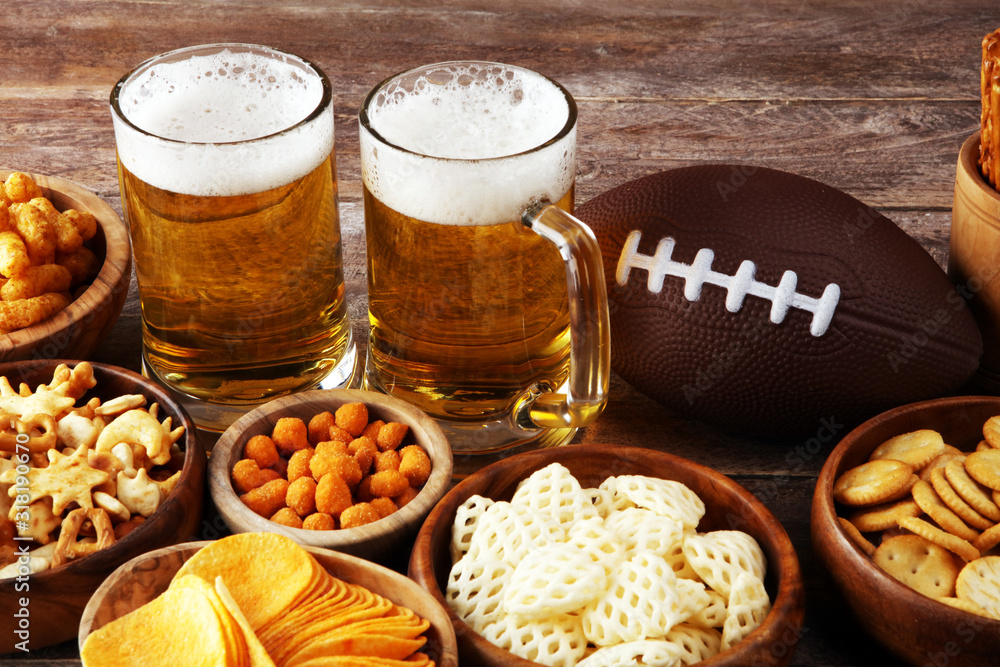 Chips, salty snacks, football and Beer on a table. Great for Bowl Game snack projects. Chips, salty snacks, football and Beer on a table. Great for Bowl Game snack projects.