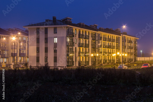 Typical architecture of village suburb of Solnechnogorsky District, Moscow region, Russia. Small modern colorful city in autumn rainy evening. Four-storey multi-panel apartment house. four floor house photo