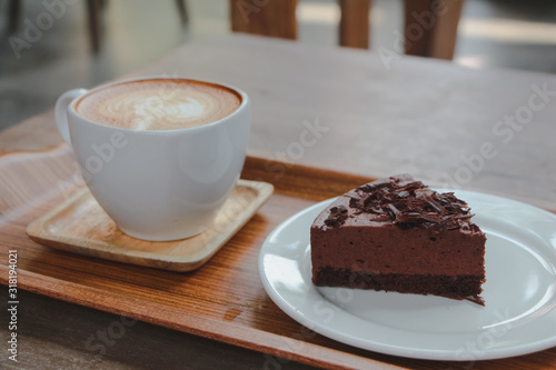 Chocolate cake with latte art coffee. 