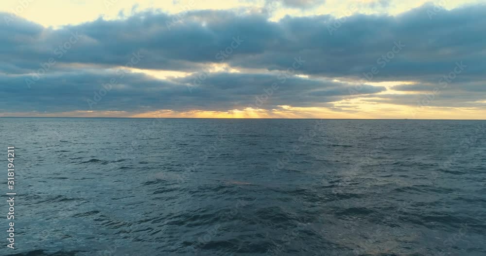 Aerial top view of peaceful calm dark blue sea water surface, cloudy sunset or sunrise sky. 4k drone video footage. Aerial top view of peaceful calm dark blue sea water surface, cloudy sunset or sunrise sky. 4k drone video footage.