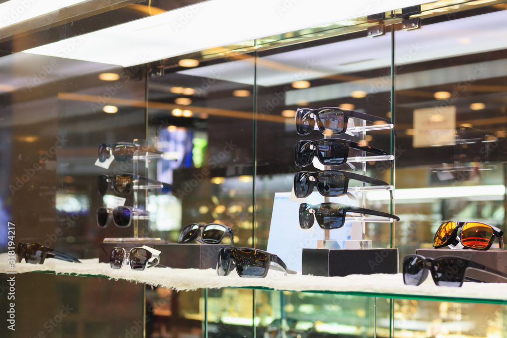 glasses and eyeglasses show in luxury retail optical store window display showcase
