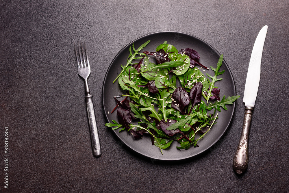 Healthy food, salad mix with arugula, spinach, bulls blood, beet leafs and micro greens Healthy food, salad mix with arugula, spinach, bulls blood, beet leafs and micro greens
